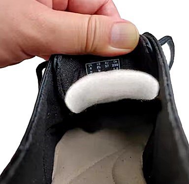 A tongue pad placed properly in the tongue of a shoe